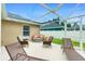 Screened-in patio with lounge seating and an outdoor ceiling light at 1247 Nora Ln, North Port, FL 34286