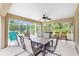 Relaxing covered patio featuring an outdoor dining area, lounge chairs and view of the outdoors at 1247 Nora Ln, North Port, FL 34286