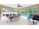 Covered patio with outdoor dining area, seating, ceiling fan, and a view of the pool at 1247 Nora Ln, North Port, FL 34286