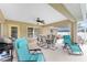 Spacious covered patio with lounge chairs, dining area, and a grill, perfect for outdoor entertaining at 1247 Nora Ln, North Port, FL 34286