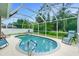 Inviting screened-in pool featuring a beautiful blue tile surround and relaxing lounge chairs at 1247 Nora Ln, North Port, FL 34286