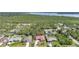 Wide aerial view illustrating neighborhood, tree coverage, and distance to nearby waterways at 13080 Proctor Ave, Port Charlotte, FL 33981