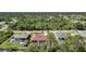 Aerial view of single-story homes, many with pools, in a lush, wooded neighborhood at 13080 Proctor Ave, Port Charlotte, FL 33981