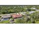 Aerial view of single-story home with screened lanai and pool, surrounded by lush trees at 13080 Proctor Ave, Port Charlotte, FL 33981