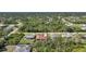 Aerial view of a well-situated home in a neighborhood with abundant trees at 13080 Proctor Ave, Port Charlotte, FL 33981