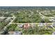 Aerial view of a neighborhood featuring lush trees, well-maintained homes, and proximity to roads at 13080 Proctor Ave, Port Charlotte, FL 33981