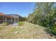 Screened-in lanai with pool and well-maintained landscaping surrounding the property provides a peaceful retreat at 13080 Proctor Ave, Port Charlotte, FL 33981