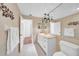 Well-lit bathroom showcases a spacious vanity with a large mirror and neutral color scheme for a relaxing atmosphere at 13080 Proctor Ave, Port Charlotte, FL 33981