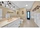 Bright bathroom features a large mirror, neutral tile, and a glass-enclosed shower for a clean and modern feel at 13080 Proctor Ave, Port Charlotte, FL 33981