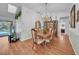 Elegant dining room featuring a chandelier, hardwood floors, and adjacent access to the kitchen at 13080 Proctor Ave, Port Charlotte, FL 33981
