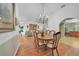 Comfortable dining area featuring hardwood floors, bright light, and access to the living room and kitchen at 13080 Proctor Ave, Port Charlotte, FL 33981