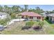Charming single-story home with well-maintained landscaping, circular driveway, and a red tile roof at 13080 Proctor Ave, Port Charlotte, FL 33981
