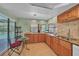 Bright and airy kitchen featuring granite countertops, natural wood cabinets, and a breakfast nook area at 13080 Proctor Ave, Port Charlotte, FL 33981