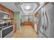 Well-equipped kitchen featuring stainless steel appliances, tile backsplash, and tiled floors at 13080 Proctor Ave, Port Charlotte, FL 33981