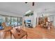 Spacious living area with hardwood floors and an open layout seamlessly connected to the dining area at 13080 Proctor Ave, Port Charlotte, FL 33981