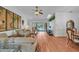 Inviting living room featuring hardwood floors, ample natural light, and sliding doors to the lanai/pool area at 13080 Proctor Ave, Port Charlotte, FL 33981