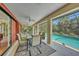 Relaxing screened-in patio offers outdoor dining space with a view of the sparkling pool at 13080 Proctor Ave, Port Charlotte, FL 33981