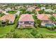 This aerial view showcases a home's screened-in patio, spa, and lush surroundings in a desirable neighborhood at 13282 Scrub Jay Ct, Port Charlotte, FL 33953