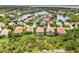 This aerial shot showcases a beautiful home and the screened in patio amidst a lush tropical landscape at 13282 Scrub Jay Ct, Port Charlotte, FL 33953