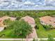 Aerial view of property with red brick driveway, well-manicured lawn and landscaping at 13282 Scrub Jay Ct, Port Charlotte, FL 33953