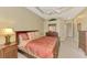 Spacious bedroom with ceiling fan, dresser, nightstand, and plenty of closet space at 13282 Scrub Jay Ct, Port Charlotte, FL 33953