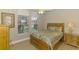 Bedroom featuring a wood bed frame, neutral walls, and two windows allowing for ample natural light at 13282 Scrub Jay Ct, Port Charlotte, FL 33953