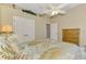 Bedroom featuring a ceiling fan, vaulted ceilings with decor, and tropical patterned bedding at 13282 Scrub Jay Ct, Port Charlotte, FL 33953