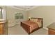 Comfortable bedroom featuring a ceiling fan, a cozy chair, and natural light from the window at 13282 Scrub Jay Ct, Port Charlotte, FL 33953