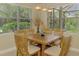 Charming dining area bathed in natural light, with a wood table that seats six at 13282 Scrub Jay Ct, Port Charlotte, FL 33953