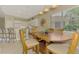 Bright dining room with bar seating, wooden table with chairs, and a stylish light fixture at 13282 Scrub Jay Ct, Port Charlotte, FL 33953