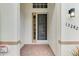 Inviting covered entryway with a decorative front door and brick flooring, leading into the home at 13282 Scrub Jay Ct, Port Charlotte, FL 33953