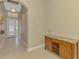 Elegant entryway featuring a wine rack cabinet, neutral paint, and tile flooring at 13282 Scrub Jay Ct, Port Charlotte, FL 33953
