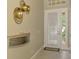 Elegant entryway featuring neutral paint, tile flooring, and a decorative wall shelf at 13282 Scrub Jay Ct, Port Charlotte, FL 33953
