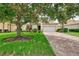 Beautiful single-story home showcasing a brick driveway, two-car garage, and a lush green lawn at 13282 Scrub Jay Ct, Port Charlotte, FL 33953