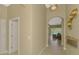 Elegant hallway featuring neutral paint, tile flooring, and arched doorway leading to living areas at 13282 Scrub Jay Ct, Port Charlotte, FL 33953