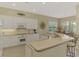Bright kitchen features white cabinets, breakfast bar and stainless steel appliances at 13282 Scrub Jay Ct, Port Charlotte, FL 33953