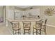Charming kitchen with white cabinetry, a breakfast bar and seating at 13282 Scrub Jay Ct, Port Charlotte, FL 33953