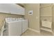 Laundry room equipped with a washer, dryer, utility sink and ample storage space at 13282 Scrub Jay Ct, Port Charlotte, FL 33953