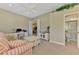 Bright living room featuring a ceiling fan, work space, and view to the ensuite bathroom at 13282 Scrub Jay Ct, Port Charlotte, FL 33953