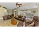 Large living room with breakfast bar, modern ceiling fan and comfortable seating area at 13282 Scrub Jay Ct, Port Charlotte, FL 33953