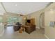 Spacious living room with tile flooring, comfortable leather furniture, and a large sliding glass door to the patio at 13282 Scrub Jay Ct, Port Charlotte, FL 33953