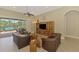 Spacious living room features tile floors, stylish furnishings, and sliding doors to outdoor patio at 13282 Scrub Jay Ct, Port Charlotte, FL 33953