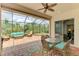 Spacious screened-in patio with a dining table, seating area, and hot tub overlooking a private yard at 13282 Scrub Jay Ct, Port Charlotte, FL 33953