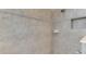 Shower featuring neutral toned tile with inset soap holder and shower head at 13282 Scrub Jay Ct, Port Charlotte, FL 33953