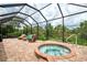 Enjoy this private screened-in spa with lush landscaping, perfect for relaxation and entertaining at 13282 Scrub Jay Ct, Port Charlotte, FL 33953