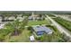 Aerial view of a property with a screened-in pool, storage shed, and surrounding greenery at 13703 Drysdale Ave, Port Charlotte, FL 33981