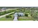 Spacious property featuring lush landscaping, a well-maintained lawn, and a charming single-Gathering home at 13703 Drysdale Ave, Port Charlotte, FL 33981