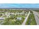 Community aerial view, lush landscaping, waterway and roads in the background at 13703 Drysdale Ave, Port Charlotte, FL 33981