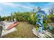 Unique backyard with artistic dolphin features, lush bamboo, and tropical foliage at 13703 Drysdale Ave, Port Charlotte, FL 33981