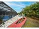View of the pool and backyard with lush bamboo and mature plantings behind the screen at 13703 Drysdale Ave, Port Charlotte, FL 33981